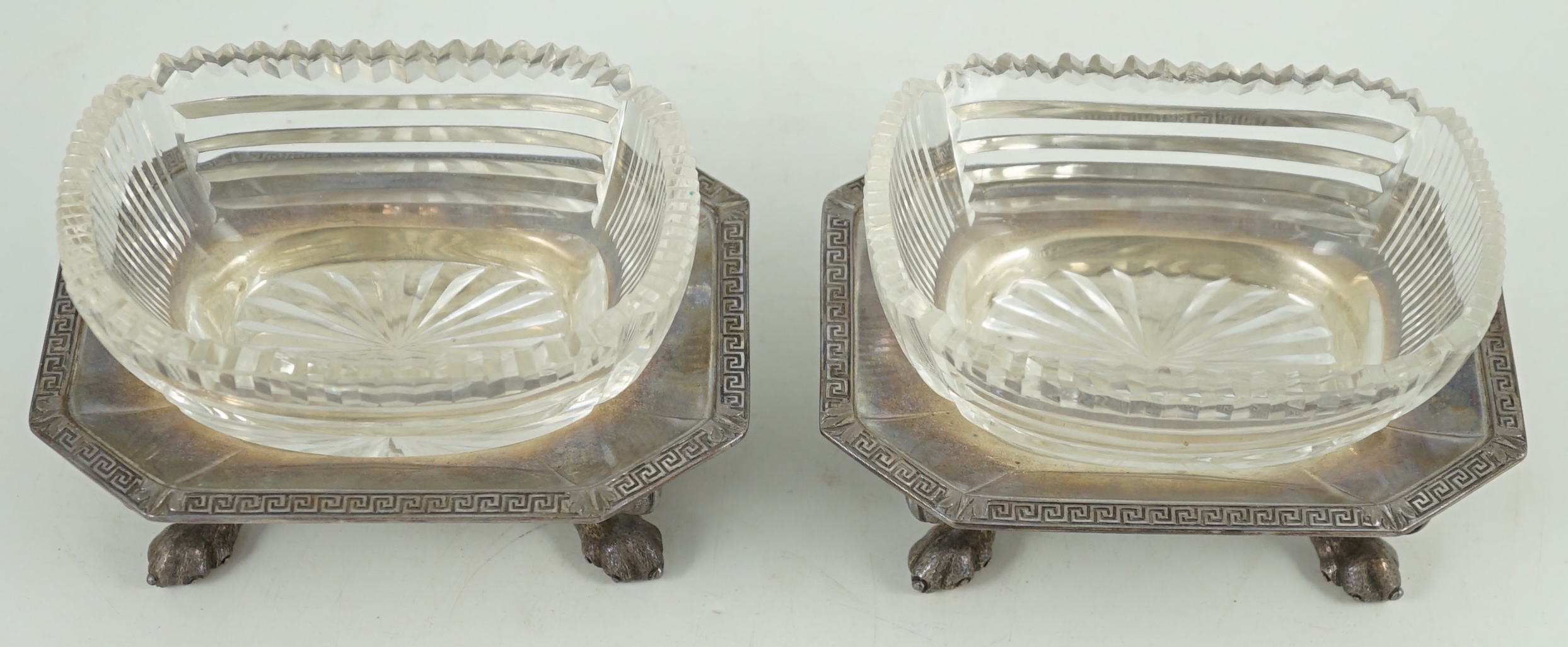 A pair of George V silver salt cellars, with cut glass liners